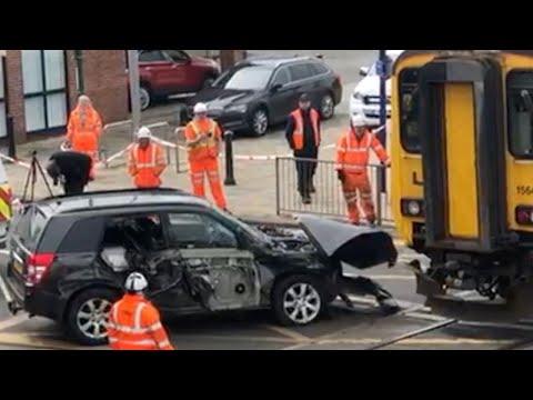 Car is pulled off the tracks after being crushed by train at crossing | SWNS [Video]
