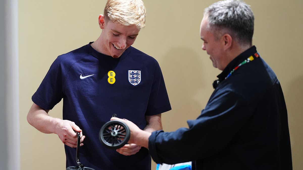 Grinning England star Anthony Gordon accepts cycling survival kit gift from Mail Sport after bike ride crash threw him 10 foot in the air and left him with cuts at the Euros [Video]